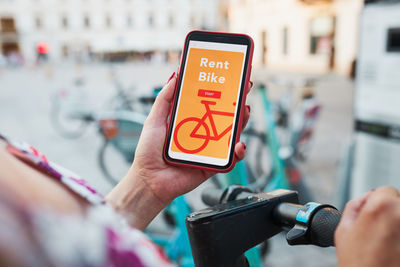 Renting bike using application on mobile phone. using bike sharing city service. public transport