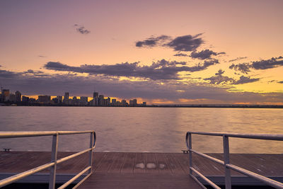 View of city at waterfront during sunset