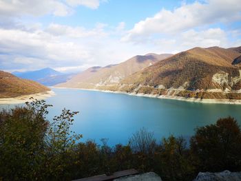 Scenic view of lake and mountains against sky