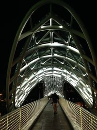 Full length of woman walking in tunnel