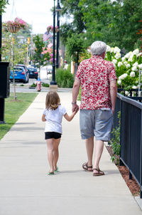 Little girl taking a walk with grandpa