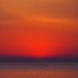 Scenic view of sea against orange sky