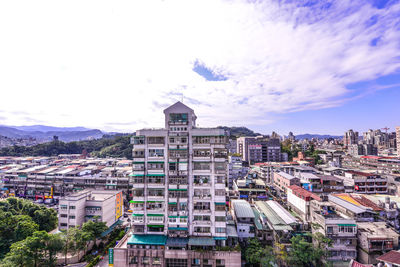 High angle view of city against cloudy sky