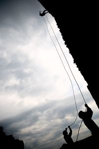 Low angle view of cables against sky