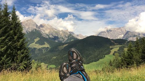 Low section of man standing on mountain in forest