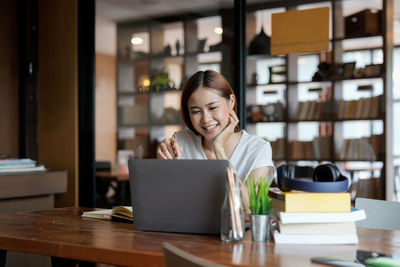 Businesswoman using laptop at table