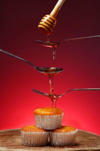 Honey pouring on cupcake