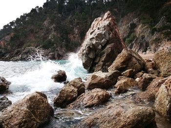 Close-up of water flowing at beach against sky