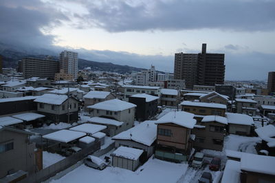 High angle view of buildings in city against sky