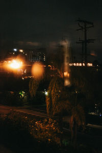 Illuminated city against sky at night