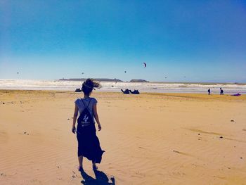 Full length of man on beach against sky