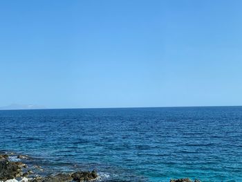 Scenic view of sea against clear blue sky