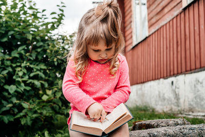 Portrait of a girl holding book