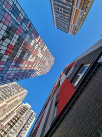 Low angle view of buildings against clear blue sky