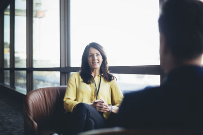 Female entrepreneur talking to male colleague in office