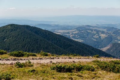 Scenic view of landscape and mountains against sky