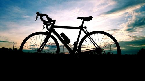 Silhouette bicycle against sky during sunset