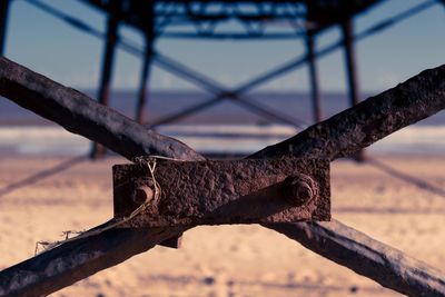 Close-up of rusty metal against sky