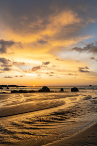 Scenic view of beach against sky during sunset
