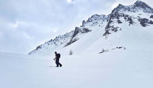 Man skiing against mountains during winter