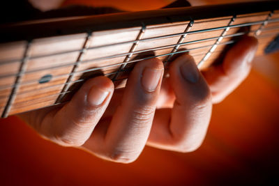 Close-up of hands playing guitar