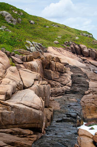 Rock formation on land against sky