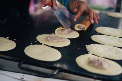 Midsection of person preparing food in kitchen