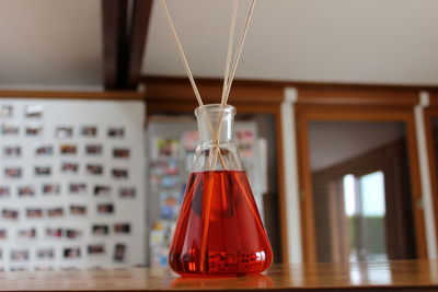 Close-up of red liquid in flask on table