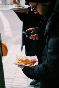 Midsection of man eating food