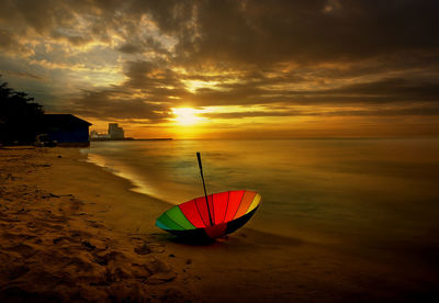 Scenic view of beach against sky during sunset