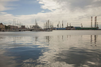 Sailboats in sea against sky