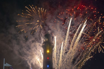 Low angle view of fireworks in sky at night