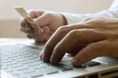 Midsection of woman using mobile phone