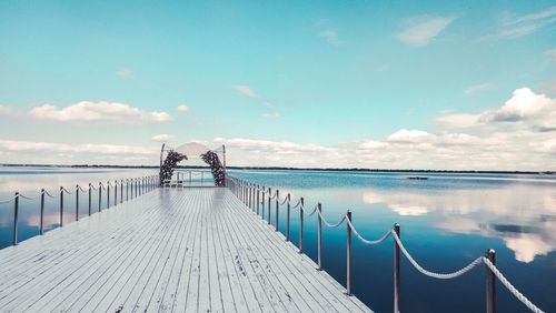 Pier over sea against sky