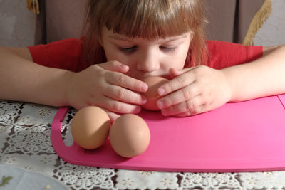 Close-up of cute baby girl on table