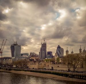 View of cityscape against cloudy sky