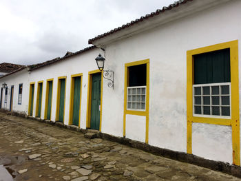 Exterior of house by building against sky