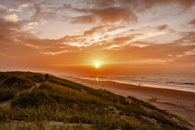 Scenic view of beach against sky during sunset