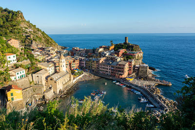 High angle view of sea and buildings against sky