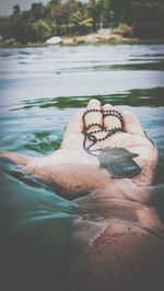 Close-up of woman hand in swimming pool