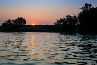 Scenic view of lake against sky during sunset