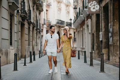 Woman and man walking together in alley