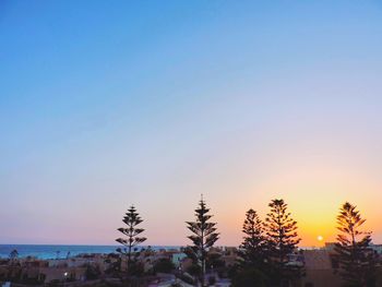 Scenic view of landscape against clear sky at sunset