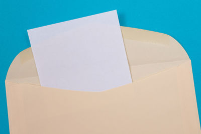 High angle view of white paper against blue background