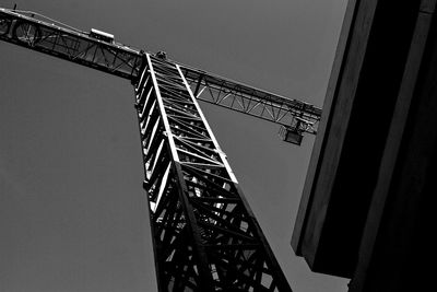 Low angle view of crane against sky