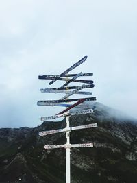 Low angle view of information sign against sky