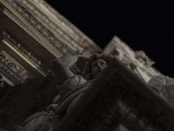 Low angle view of statue against building