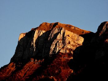 Low angle view of rock formation against sky