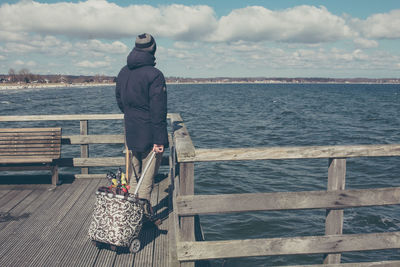 Woman sitting on pier