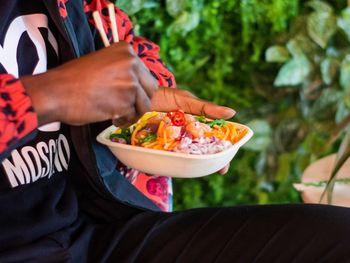 Midsection of man holding food